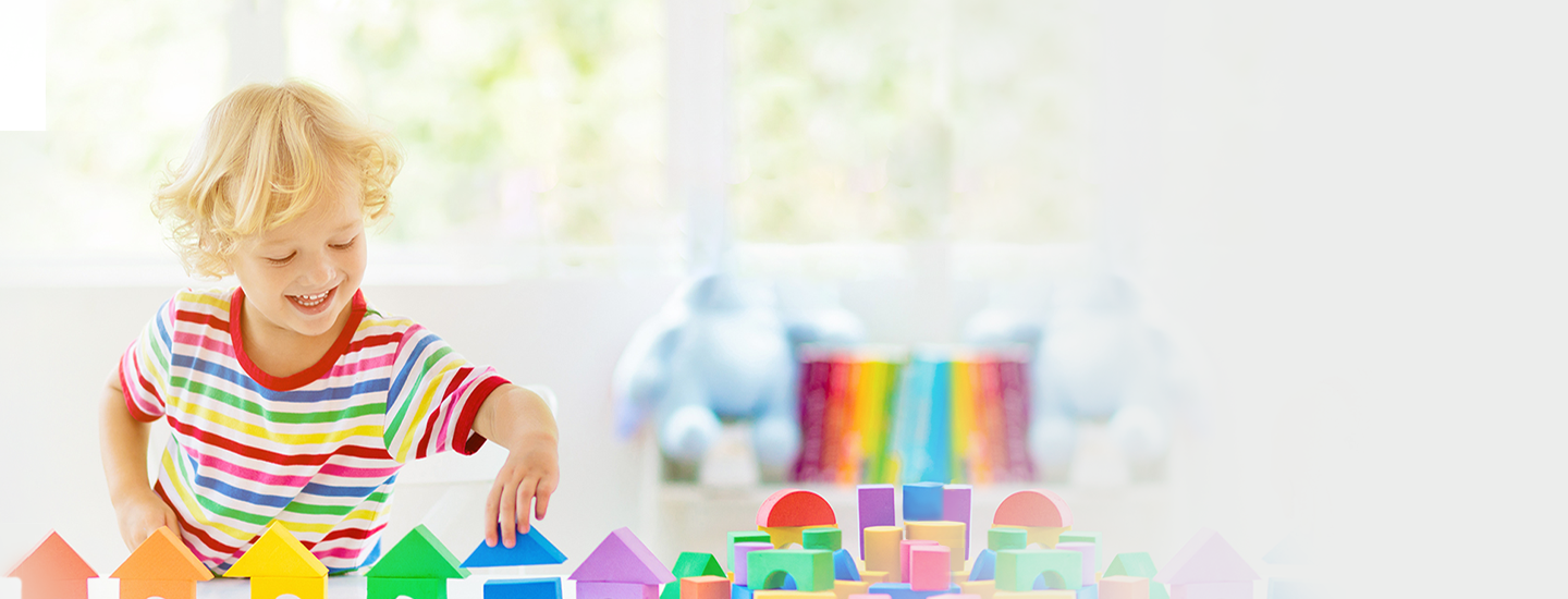 Young child building with colorful blocks